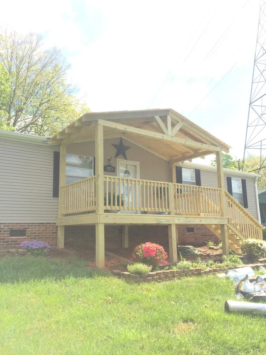 New gabled porch roof and deck railing added to a ranch home in Woodside